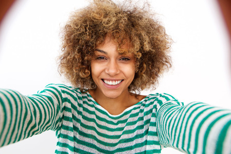 Portrait of attractive young african american woman taking selfieの写真素材