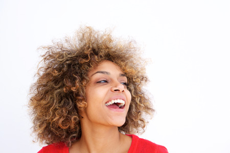 Close up portrait of beautiful black young woman with curly hair laughing