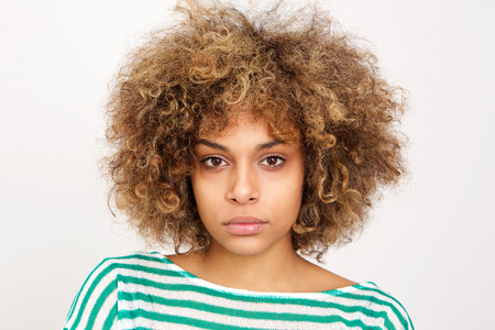 Close up portrait of serious young african american woman against white background