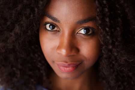 Close up portrait of attractive young african woman with curly hairの写真素材