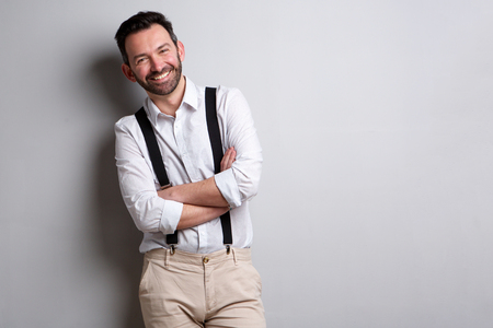 Portrait of happy man with beard posing against gray wallの写真素材