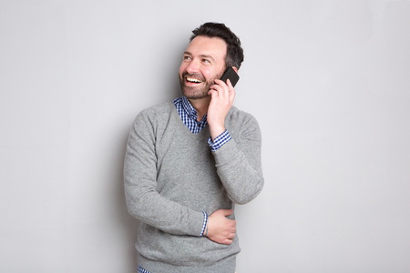 Portrait of happy businessman talking on cellphone の写真素材