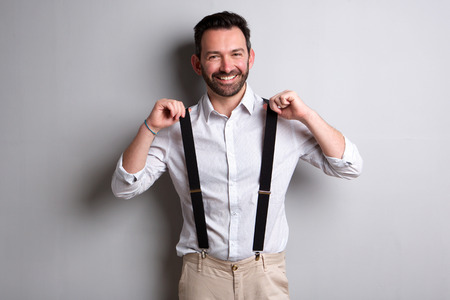 Portrait of trendy man with beard holding suspendersの写真素材