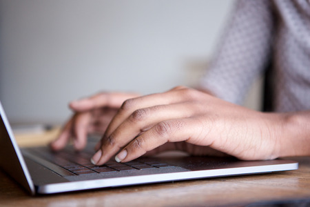 close up portrait of female hands typing on laptop computer