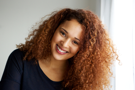 Close up portrait of beautiful young black woman with curly hairの写真素材