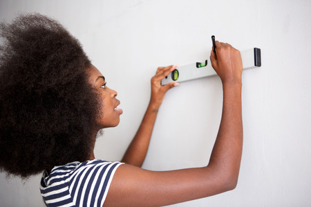 Portrait of young black woman doing diy at home