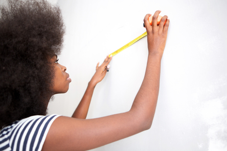 Portrait of attractive young black woman doing home improvementの写真素材