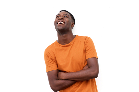 Portrait of happy young black man laughing and looking upの写真素材