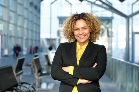 Horizontal portrait of smiling business woman with arms crossedの写真素材