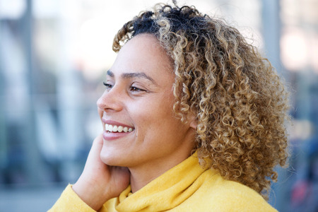 Close up side portrait of happy african american woman with curly hair