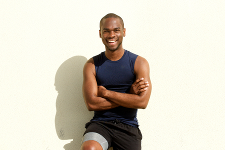 Portrait of cool young african american sports man smiling against wallの写真素材