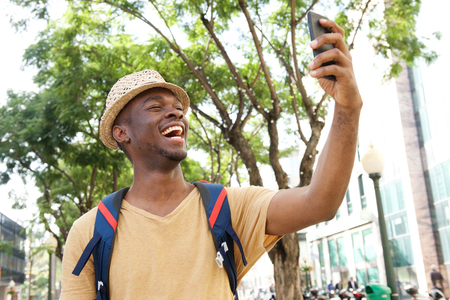 Portrait of happy african american tourist taking selfie photosの写真素材
