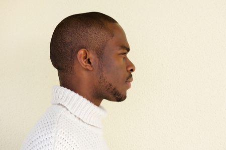 Close up profile portrait of serious african american man in sweaterの写真素材