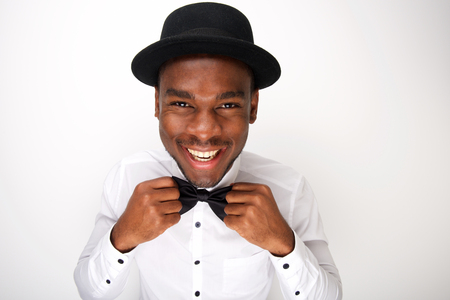Close up portrait of smiling african american man adjusting his bowtieの写真素材