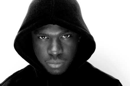 Close up black and white portrait of young black man with hoodieの写真素材