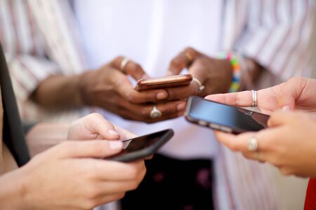 Close up female hands holding mobile phones