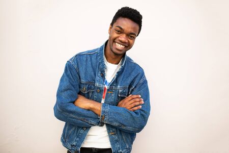 Portrait of cool african american young man with arms crossed against white background