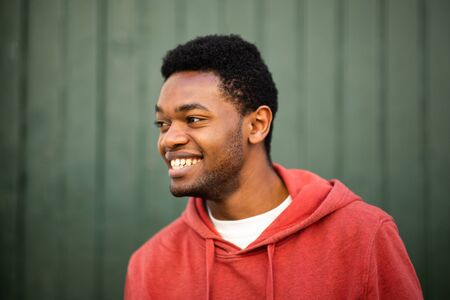 Close up horizontal portrait of smiling young african man looking awayの写真素材