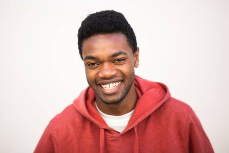 Close up horizontal portrait young black man smiling against white background