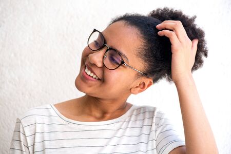 Close up portrait of young african american girl with glasses scratching her head