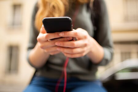 Close up portrait of young woman hands holding mobile phone