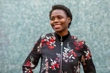 Portrait beautiful young african woman smiling and looking awayの写真素材