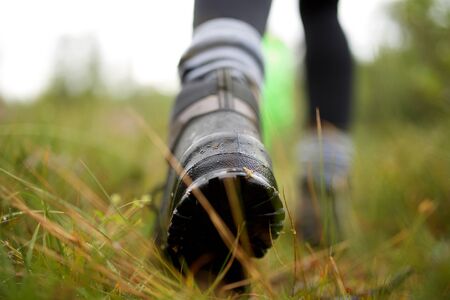 Close up hiker boot walking on trail outdoors
