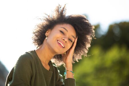 Close up portrait beautiful young black woman smiling outdoors