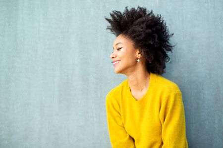Profile portrait beautiful young woman smiling with afro hair