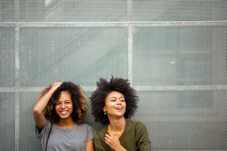Portrait two young african american woman laughing with afro hairの写真素材