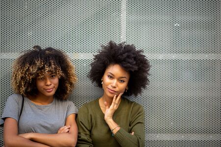 Portrait two cool young black woman with afro hairの写真素材