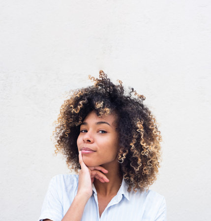 Close up portrait young african american woman with curly hair thinkingの写真素材