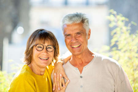 Portrait from back of older couple sitting on park bench