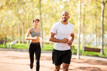 couple demonstrates the power of teamwork and commitment to health and fitness. Jogging in a park