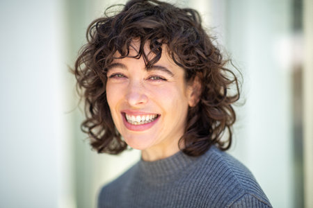 Close-up portrait of beautiful young woman with short hair looking at camera and smilingの写真素材