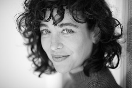 Close up black and white portrait of beautiful young woman staring at cameraの写真素材