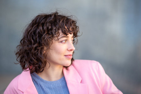 Close-up side portrait of beautiful young woman looking away