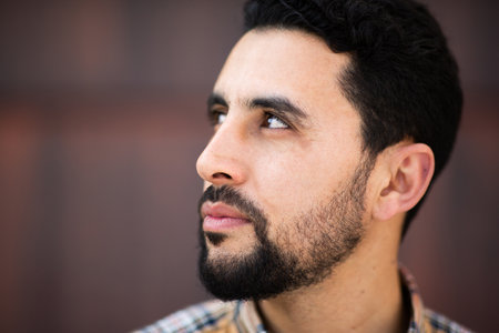 Close up portrait of serious arabic man with beard looking awayの写真素材