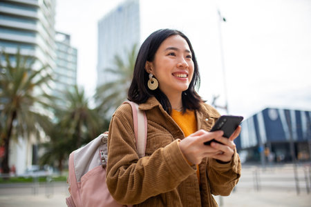 Portrait young woman with bag and cellphoneの写真素材