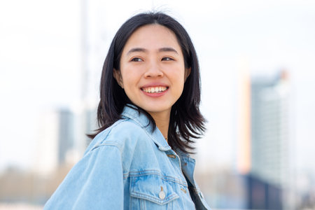 Side portrait young asian woman smilingの写真素材