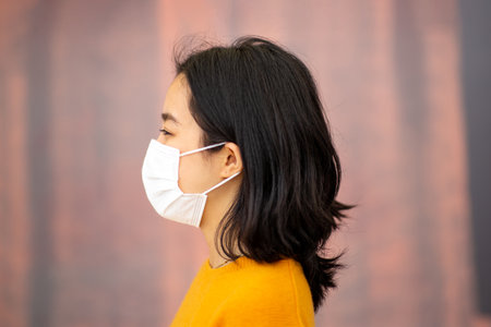 Profile portrait young asian woman with maskの写真素材