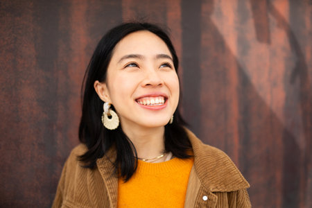 Close up portrait smiling young woman looking upの写真素材