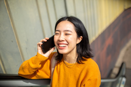 Portrait happy young asian woman talking with mobile phone