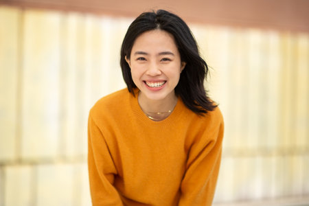 Smiling portrait young attractive asian woman looking at cameraの写真素材