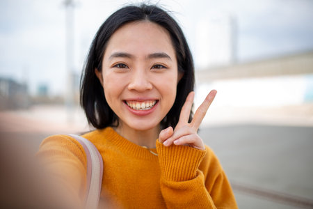 Selfie portrait happy young asian womanの写真素材