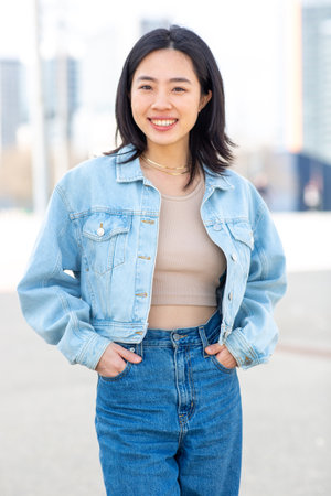 Portrait smiling young asian woman with denim jacketの写真素材