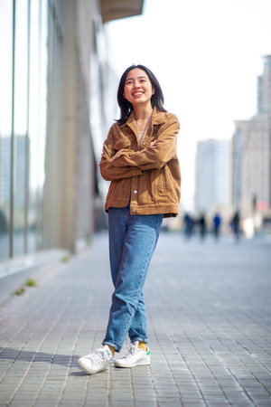 Full body portrait young asian woman smiling in cityの写真素材