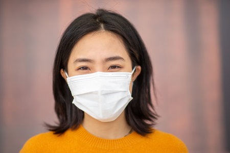 Pandemic portrait young asian woman with maskの写真素材