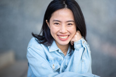 Portrait young asian woman smiling and looking at cameraの写真素材