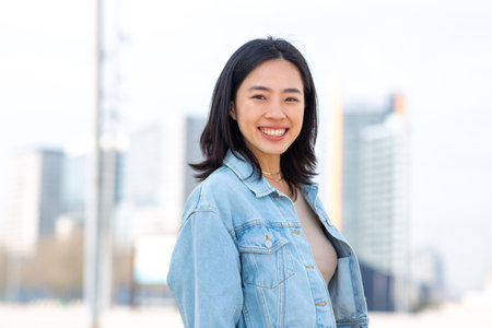 Portrait young woman smiling outsideの写真素材